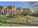 Well-maintained backyard featuring a grassy lawn, mature trees, and privacy shrubs creating a serene outdoor space at 6492 Simms St # A, Arvada, CO 80004
