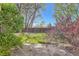 A lush green backyard features mature trees and a privacy fence at 6492 Simms St # A, Arvada, CO 80004