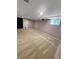 Finished basement features neutral carpet, a small window, and access door at 6492 Simms St # A, Arvada, CO 80004