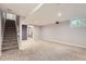 This finished basement includes neutral carpet, stairs, storage area and a window for natural light at 6492 Simms St # A, Arvada, CO 80004