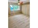 Bedroom featuring carpet, window with trees, and a large closet at 6492 Simms St # A, Arvada, CO 80004