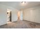 Bedroom with carpet and doors to closets and bathroom at 6492 Simms St # A, Arvada, CO 80004