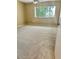 Bedroom with neutral walls and carpet and a large window with green trees outside at 6492 Simms St # A, Arvada, CO 80004