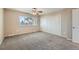 Bedroom featuring closet and window with tree view at 6492 Simms St # A, Arvada, CO 80004