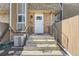 Inviting entryway with concrete steps, wrought iron railing, and a well-maintained exterior at 6492 Simms St # A, Arvada, CO 80004