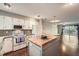 Bright kitchen with white cabinets, granite countertops, mosaic backsplash and hardwood floors at 6492 Simms St # A, Arvada, CO 80004