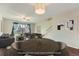 Staged living room with dining table, staircase, and sliding door to the backyard at 6492 Simms St # A, Arvada, CO 80004
