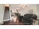 Open-concept living room with staircase, dining area, and comfortable seating arrangement at 6492 Simms St # A, Arvada, CO 80004