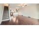 Open-concept space with hardwood floors and stairs to the upper level at 6492 Simms St # A, Arvada, CO 80004