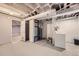 Unfinished utility room in the basement has concrete floors, laundry hookups and plenty of open space at 6492 Simms St # A, Arvada, CO 80004
