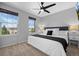 Bedroom with two large windows, ceiling fan and white bedding at 2880 Breezy Ln, Castle Rock, CO 80109
