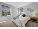 Well-lit bedroom with white linens, two windows, and neutral walls and carpet at 2880 Breezy Ln, Castle Rock, CO 80109