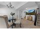 Dining area with an elegant chandelier, a glass table, and chairs, with access to stairs at 2880 Breezy Ln, Castle Rock, CO 80109
