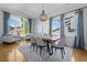 Inviting dining room with large windows, wood floors, and a rustic wooden table at 2880 Breezy Ln, Castle Rock, CO 80109