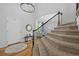 Bright foyer featuring wood floors, a staircase with iron railing and a modern chandelier at 2880 Breezy Ln, Castle Rock, CO 80109
