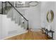 Open foyer with hardwood floors, a staircase, and elegant lighting at 2880 Breezy Ln, Castle Rock, CO 80109