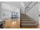 Open foyer with hardwood floors, a staircase, and elegant lighting at 2880 Breezy Ln, Castle Rock, CO 80109