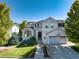 Charming two-story home with a well-manicured lawn, lovely landscaping, and a basketball hoop over the garage at 2880 Breezy Ln, Castle Rock, CO 80109