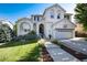 Charming two-story home with a well-manicured lawn, lovely landscaping, and a basketball hoop over the garage at 2880 Breezy Ln, Castle Rock, CO 80109