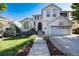 Charming two-story home with a well-manicured lawn, lovely landscaping, and a basketball hoop over the garage at 2880 Breezy Ln, Castle Rock, CO 80109