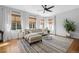 Bright living room featuring hardwood floors, large windows, and comfortable seating at 2880 Breezy Ln, Castle Rock, CO 80109