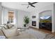 Comfortable living room with a fireplace, mounted television and hardwood floors at 2880 Breezy Ln, Castle Rock, CO 80109