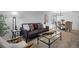 Inviting living room featuring a modern sofa, glass coffee table, and view of the dining area at 2880 Breezy Ln, Castle Rock, CO 80109