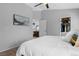 Bright main bedroom shows ensuite bathroom and closet with clothes hanging from rod at 2880 Breezy Ln, Castle Rock, CO 80109