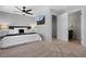 Well-lit main bedroom featuring a wall-mounted TV and an open doorway to the ensuite bathroom at 2880 Breezy Ln, Castle Rock, CO 80109