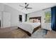 Spacious main bedroom with neutral walls, a ceiling fan, two windows, and an ensuite bathroom with walk-in closet at 2880 Breezy Ln, Castle Rock, CO 80109
