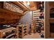 Charming wine cellar with wooden racks, displaying various bottles of wine at 2880 Breezy Ln, Castle Rock, CO 80109