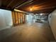 Unfinished basement with exposed ceiling and concrete floors, featuring a pool table and ample space at 16180 E Flora Pl, Aurora, CO 80013