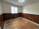 Cozy bedroom featuring wood paneling, ready for new flooring and personalization at 16180 E Flora Pl, Aurora, CO 80013