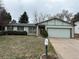 Charming single-Gathering home featuring an attached two-car garage and low maintenance landscaping at 16180 E Flora Pl, Aurora, CO 80013