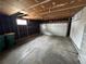 View of empty garage with concrete floor and white garage door at 16180 E Flora Pl, Aurora, CO 80013