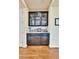 Dry bar with glass cabinets, granite countertop, tile backsplash and room for bar equipment at 10052 Isle St, Parker, CO 80134