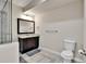 Well-lit bathroom with a dark wood vanity, granite countertop, and modern fixtures at 10052 Isle St, Parker, CO 80134
