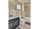 Well-lit bathroom features a vanity with granite countertops, tub, and tiled shower at 10052 Isle St, Parker, CO 80134