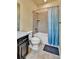 Well-lit bathroom features a shower-tub with a blue ombre curtain at 10052 Isle St, Parker, CO 80134