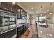 Modern kitchen featuring stainless steel appliances, granite countertops, hardwood floors and access to the outdoors at 10052 Isle St, Parker, CO 80134
