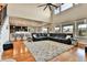 Open-concept living room featuring high ceilings, hardwood floors, and a large leather sectional sofa with bright natural light at 10052 Isle St, Parker, CO 80134