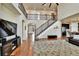 Spacious living area with hardwood floors, staircase, and contemporary decor, creating a warm and inviting atmosphere at 10052 Isle St, Parker, CO 80134
