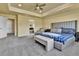 Large main bedroom featuring a tray ceiling, ceiling fan, sitting area, and ensuite access at 10052 Isle St, Parker, CO 80134