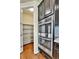 Kitchen featuring stainless steel appliances, hardwood floors and a pantry stocked with shelving at 10052 Isle St, Parker, CO 80134
