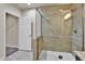 Modern glass enclosed shower features decorative tiling with a built in shower head at 10052 Isle St, Parker, CO 80134