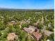 Aerial view of a home surrounded by lush trees, showcasing the landscape and neighborhood at 1420 W Ridge Rd, Littleton, CO 80120