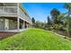 Large backyard featuring green lawn, an outdoor bar area, and a back patio at 1420 W Ridge Rd, Littleton, CO 80120