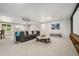Finished basement with projector screen, grey sofa and neutral decor for a cozy entertainment space at 1420 W Ridge Rd, Littleton, CO 80120