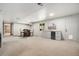Basement area featuring table, chairs, and kitchenette with mini fridge and sink near walkout entrance at 1420 W Ridge Rd, Littleton, CO 80120