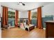 bedroom with whimsical car bed, window views, wood-look floors and modern paneling at 1420 W Ridge Rd, Littleton, CO 80120